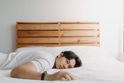 Portrait of woman lying on bed