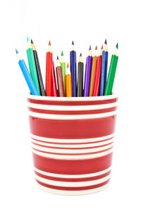 Close-up of colored pencils against white background