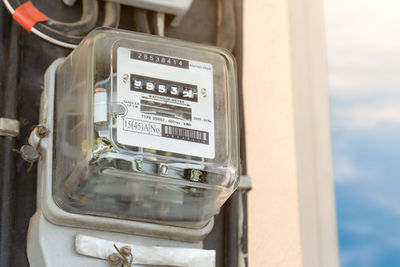 Close-up of telephone booth against sky