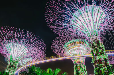 Low angle view of illuminated ferris wheel at night