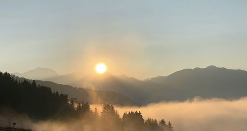 Scenic view of silhouette mountains against sky during sunset