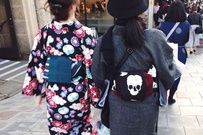 Rear view of couple walking on street