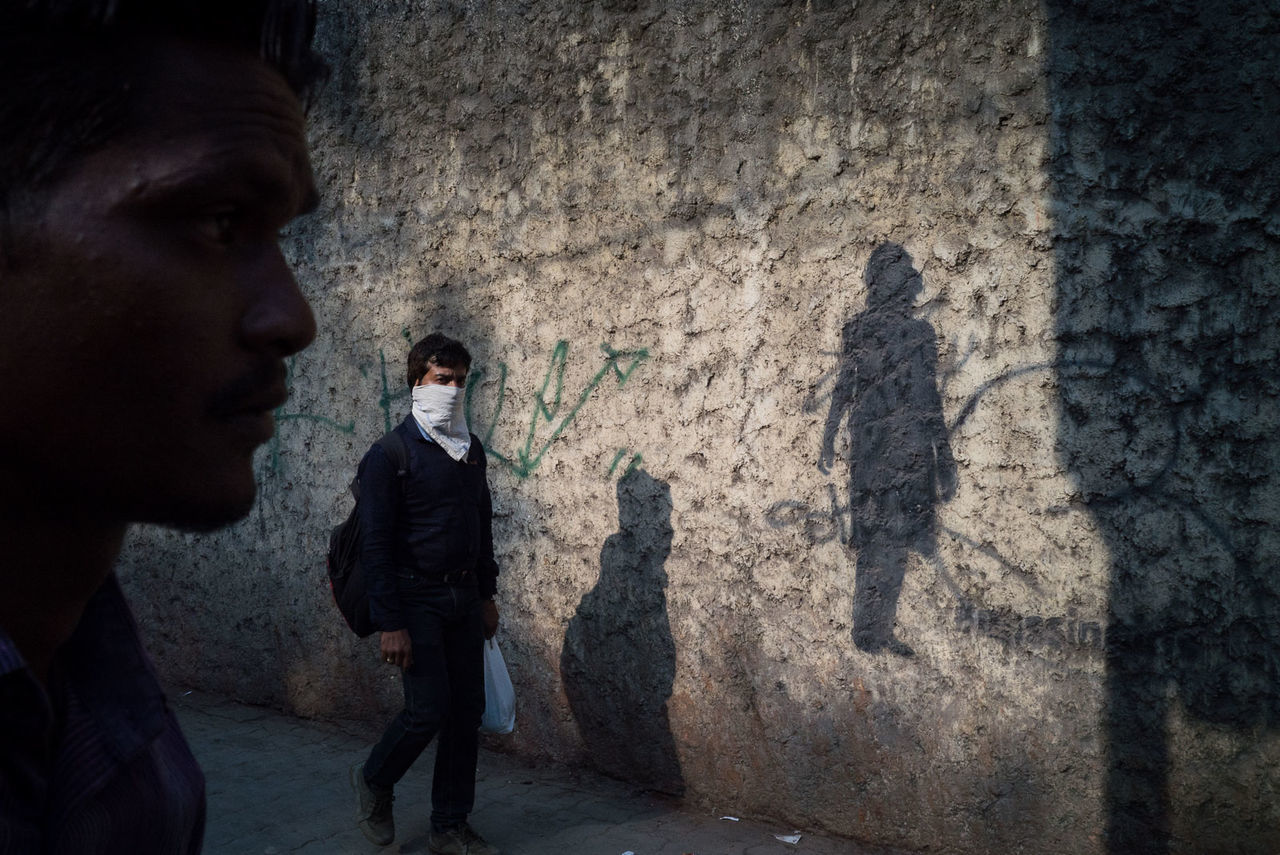 two people, shadow, outdoors, real people, built structure, boys, men, day, city, prison, young adult, people
