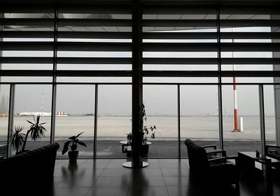 Airport runway seen through glass window