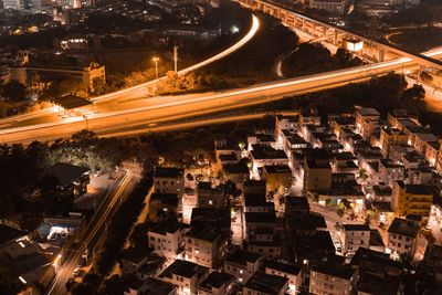 High angle view of illuminated city street and buildings at night