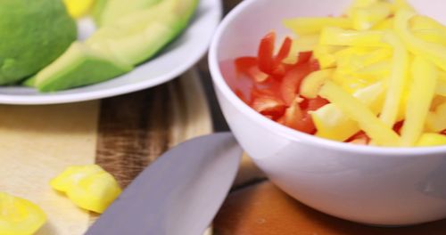 High angle view of chopped fruits in bowl on table