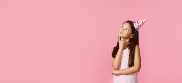 Cropped hand of woman holding plant against yellow background