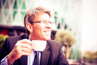 Close-up portrait of man with coffee cup