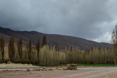 Scenic view of land and mountains against sky