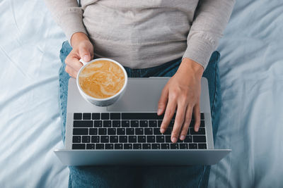 High angle view of man using laptop on table