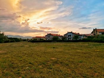 Scenic view of field against sky during sunset