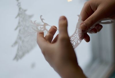 Midsection of person holding paper