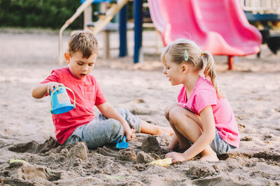 Children playing with sand at playground