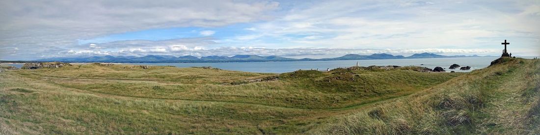 Scenic view of sea and mountains against sky