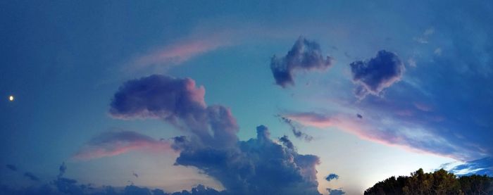 Low angle view of rainbow in sky at sunset