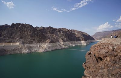 Scenic view of lake and mountains against sky