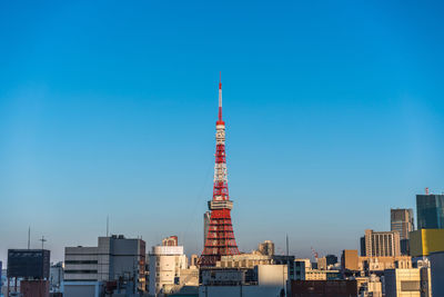 Modern buildings in city against blue sky