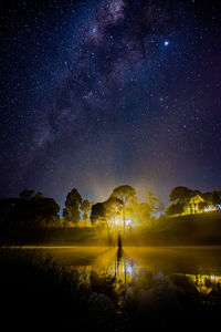 Scenic view of lake against sky at night