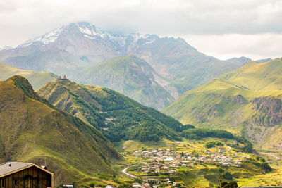 Panoramic view of kazbek mountain georgia highest point and gergeti trinity church at stepantsminda 