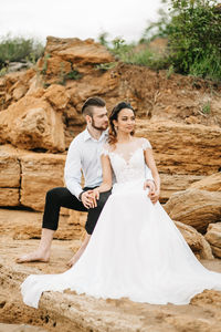 Full length of smiling young couple standing outdoors