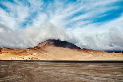 Scenic view of arid landscape against sky