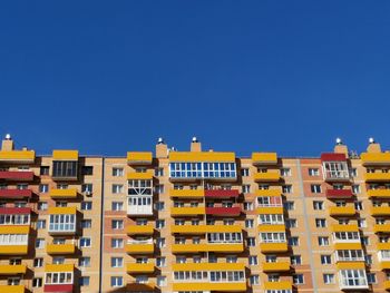 Residential buildings against clear blue sky