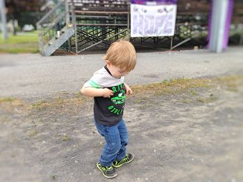 Cute boy playing on footpath