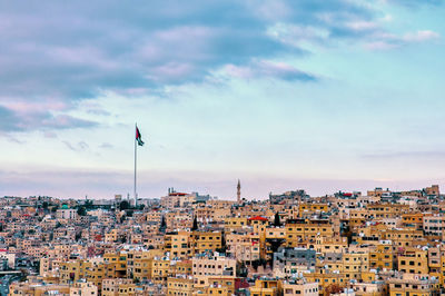 Buildings in town against sky