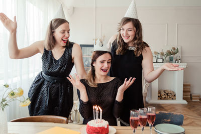 Happy women celebrating birthday at home