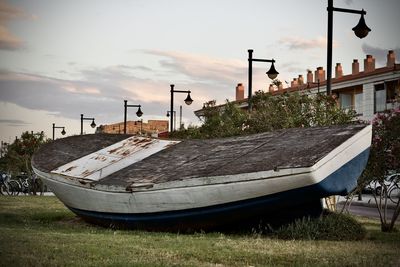 Boat moored at shore against sky