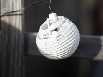 Close-up of light bulb hanging on table
