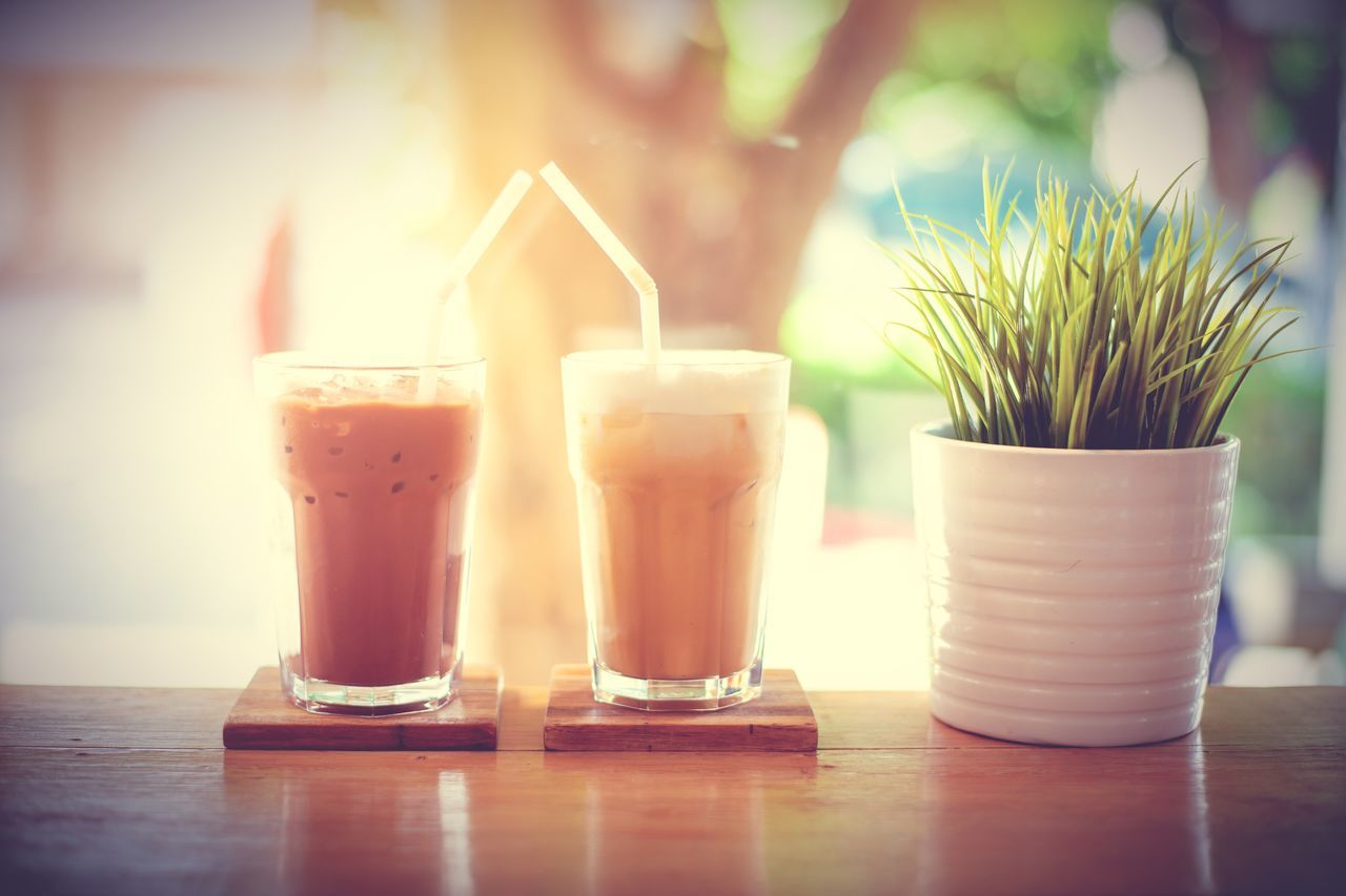 food and drink, drink, lighting, morning, table, refreshment, drinking glass, glass, household equipment, light, nature, food, plant, sunlight, indoors, no people, freshness, still life, straw, wood, close-up, cafe, focus on foreground, yellow, drinking straw, selective focus, soft drink, cup