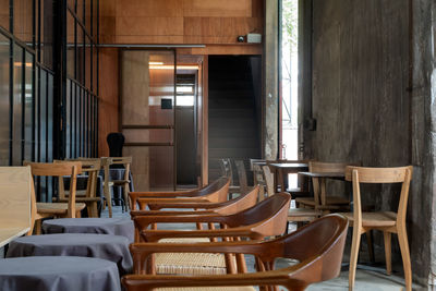 Empty chairs and tables in restaurant