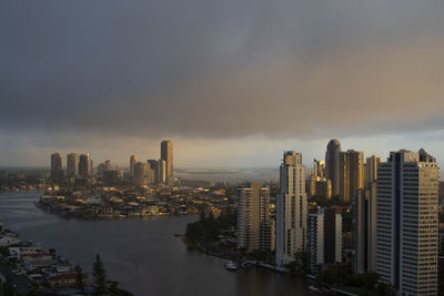 Aerial view of buildings in city against sky