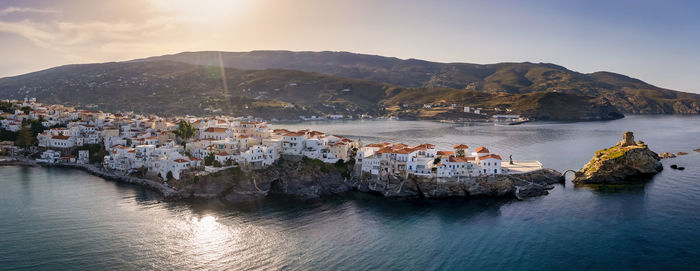 Panoramic view of sea and buildings against sky