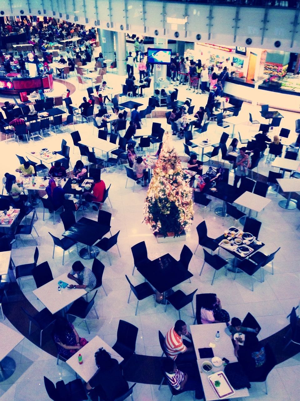 large group of objects, abundance, high angle view, variation, large group of people, in a row, arrangement, chair, order, person, lifestyles, choice, men, leisure activity, day, indoors, repetition, multi colored, shopping