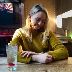 Young woman drinking glasses on table at cafe