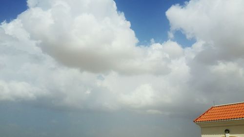 Low angle view of building against cloudy sky