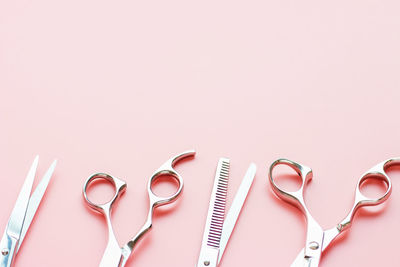 The professional scissors on a pink background with copy space.