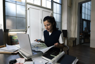 Businesswoman using laptop at office