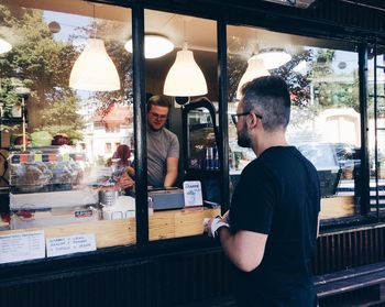 Man and woman standing in front of cafe