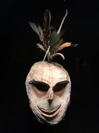 Close-up of mask against black background