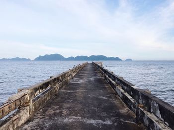 Pier over sea against sky