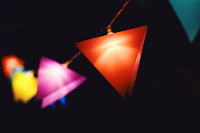 Close-up of illuminated lamp against black background