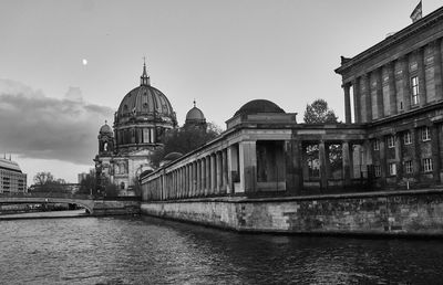 View of river by cathedral against sky