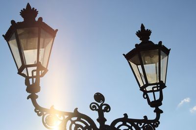 Low angle view of illuminated street light against clear sky