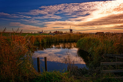 Scenic view of field against sky during sunset