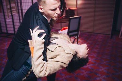 Couple dancing at illuminated nightclub