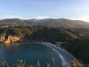 Scenic view of river and mountains against sky