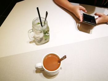 Close-up of man using laptop on table